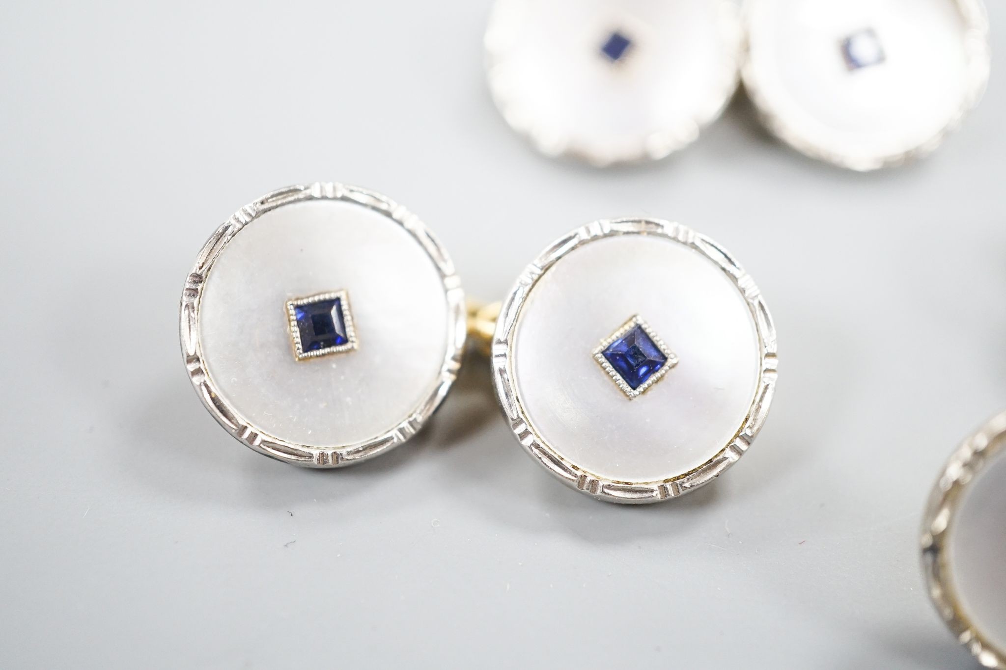 A pair of 18ct, mother of pearl and sapphire set circular cufflinks, 13mm and a pair of matching dress studs, gross weight 8.6 grams.